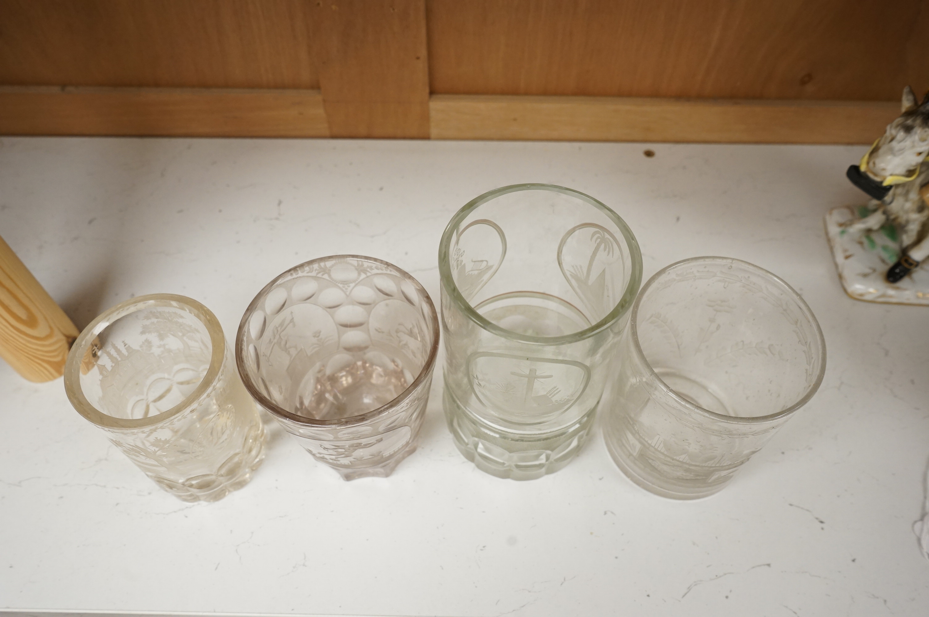 Four German or Bohemian engraved glass beakers, 19th century, largest 16cm high